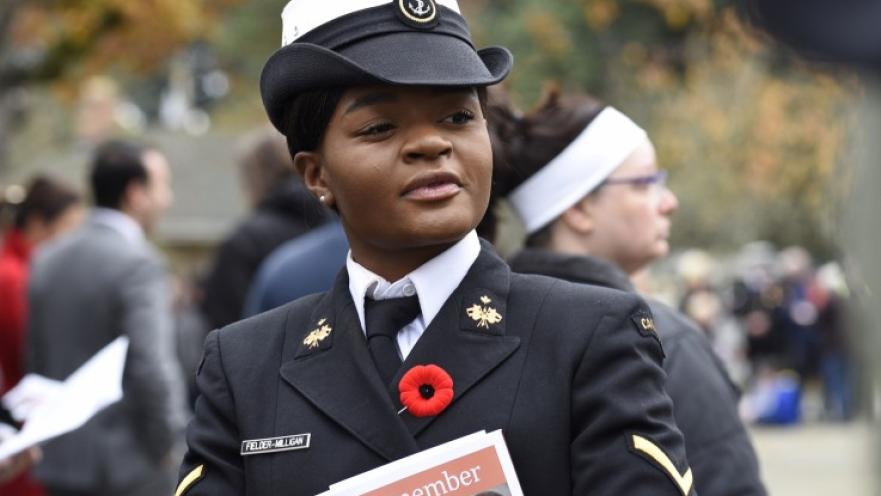 Woman soldier dressed in ceremonial armed forces uniform.