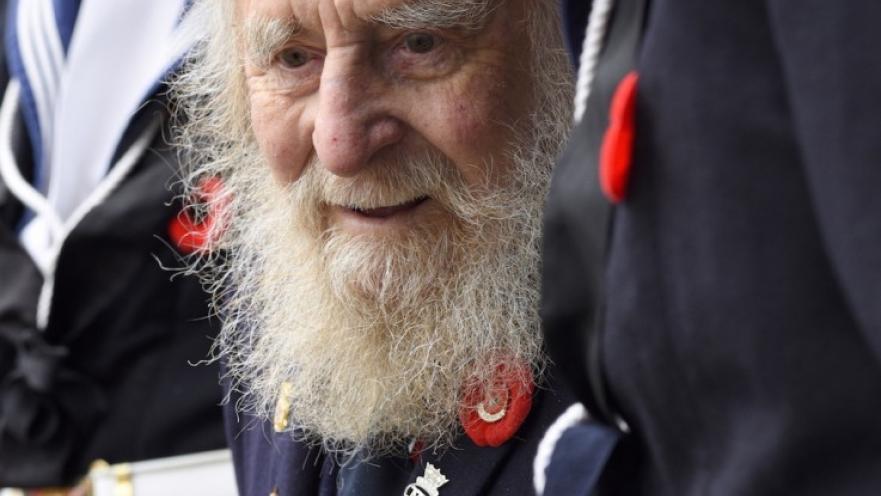 Elderly veteran dressed in ceremonial armed forces uniform.