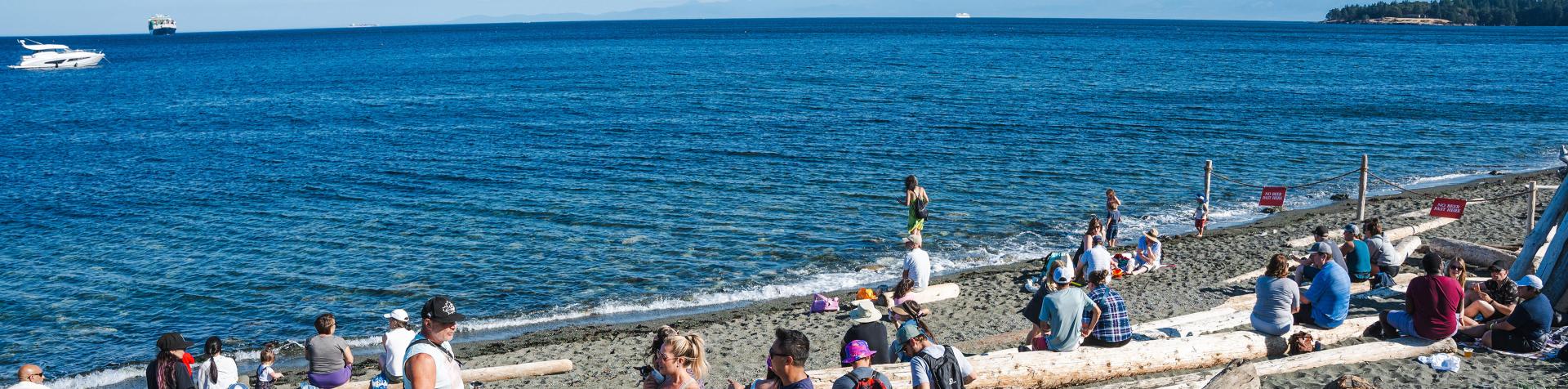 People enjoying the waterfront at the Beachlands in Colwood