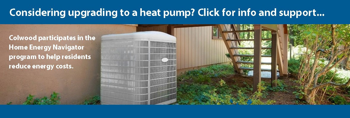 image of a heat pump next to a house