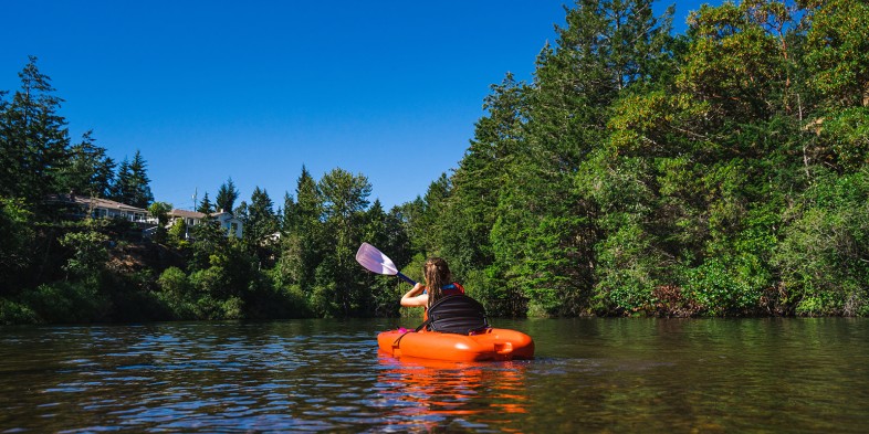 young girl paddling kayak on lookout lake