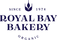 Logo of Royal Bay Bakery, established in 1974, promoting organic baked goods.