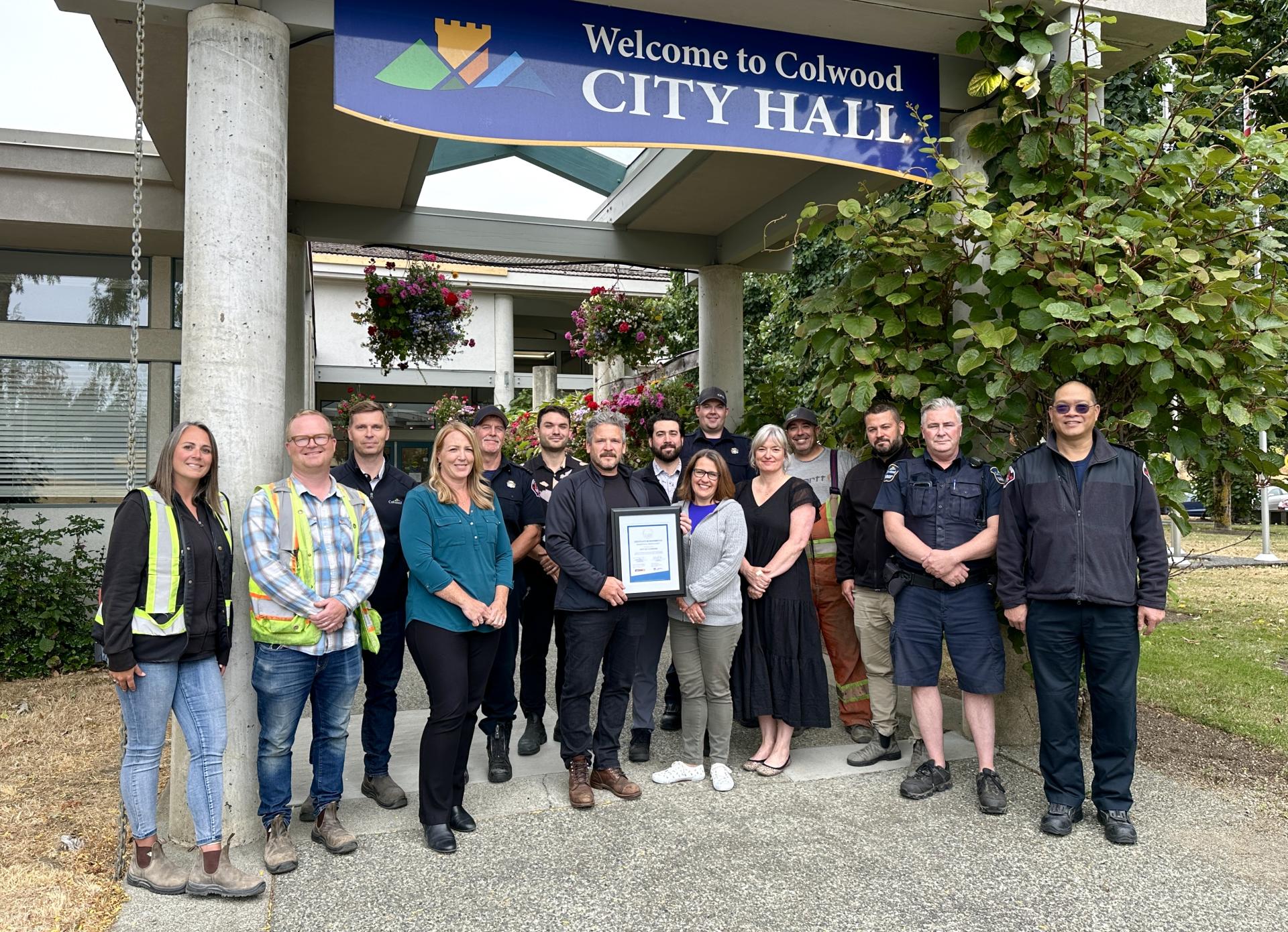staff outside city hall with cor award